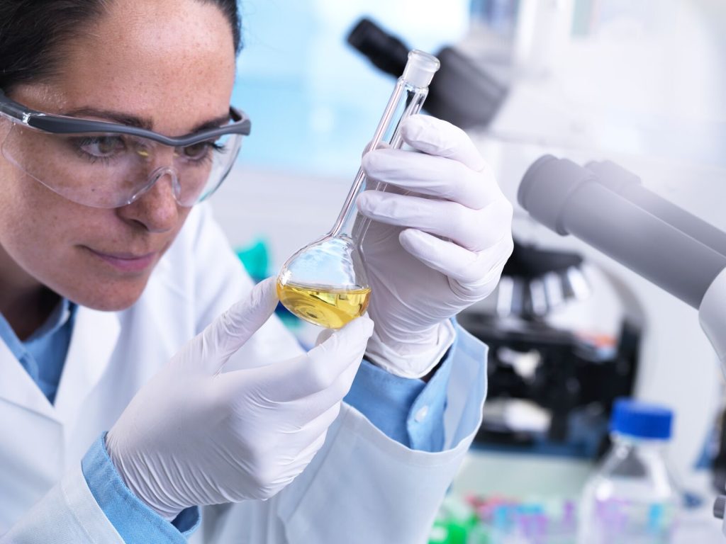 Scientist Using Flask to Mix Chemicals